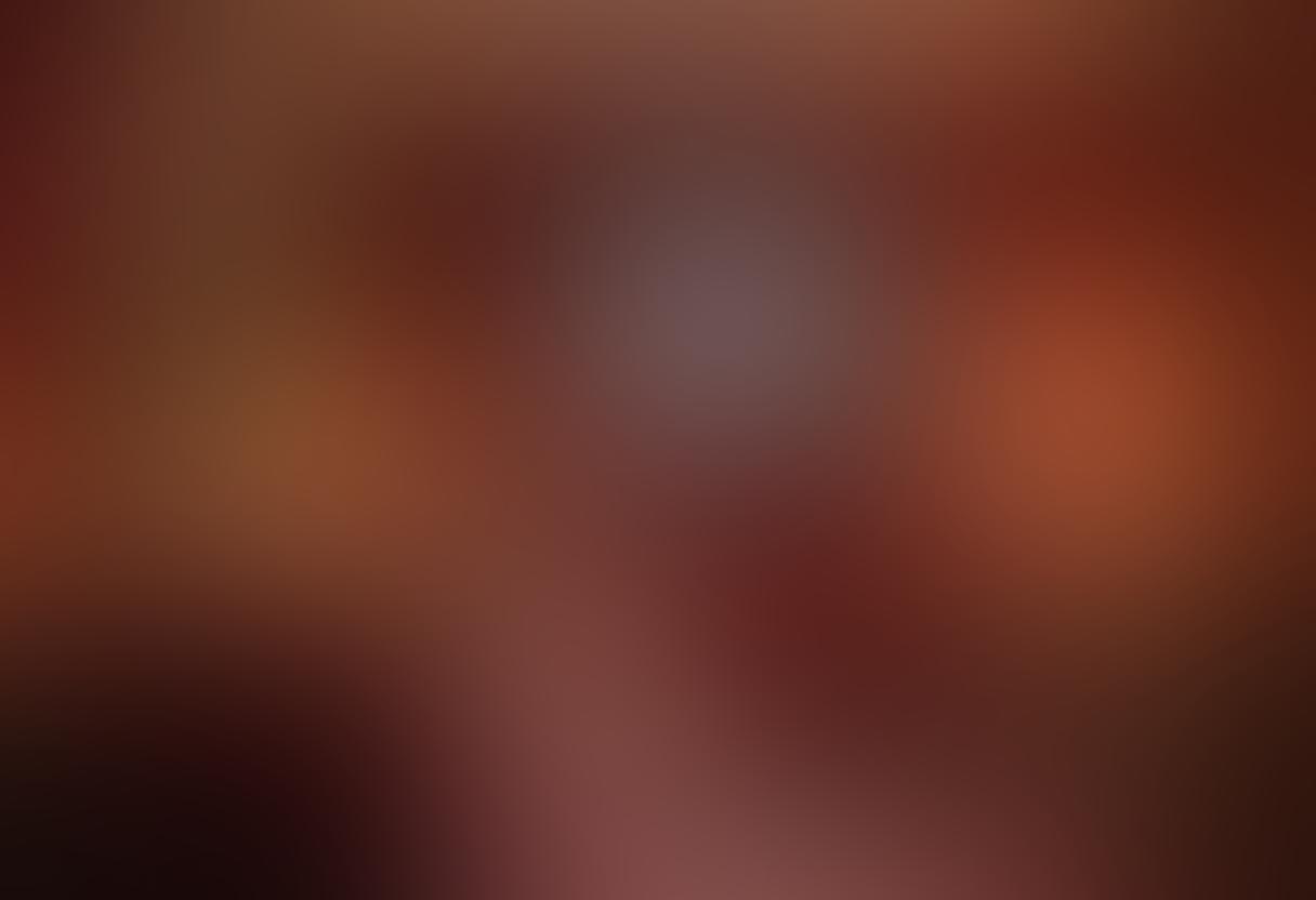 A captivating and alluring scene featuring a luxurious, dimly lit room with plush velvet curtains, a vintage film projector casting soft, romantic light onto a classic popcorn machine. In the foreground, a couple cuddles on an oversized sofa, engrossed in a captivating live show displayed on a large screen, hinting at the world of erotic streaming. The ambiance is enriched with stylish decor, whispering intimacy, and sensuality. super-realistic. vibrant colors. intimate atmosphere.